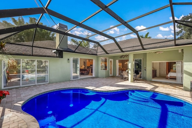 view of swimming pool with a lanai and a patio