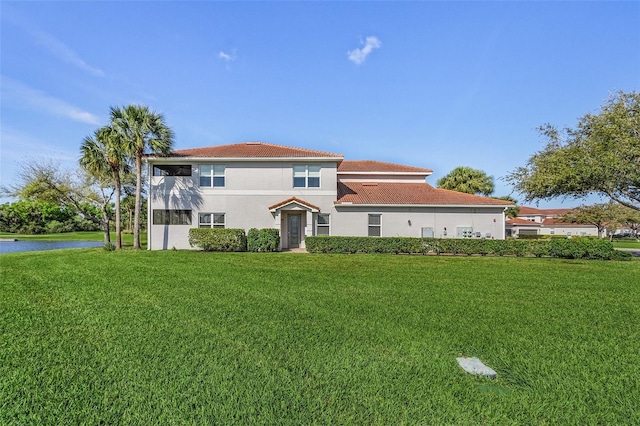 mediterranean / spanish house with a front lawn