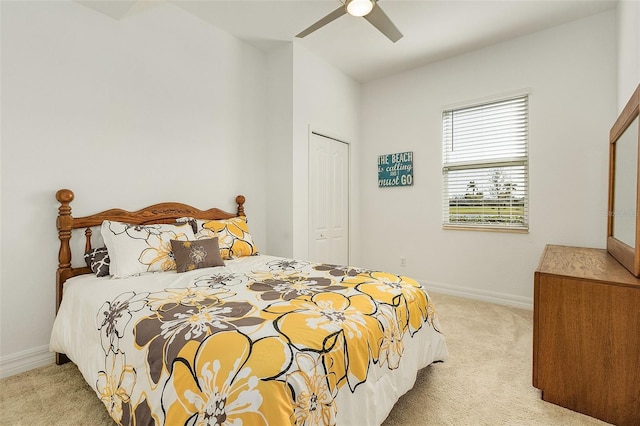 carpeted bedroom featuring ceiling fan and a closet