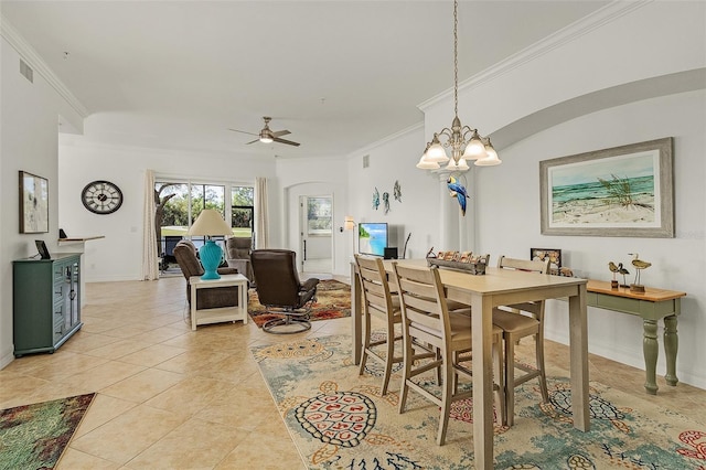 tiled dining area with crown molding and ceiling fan with notable chandelier