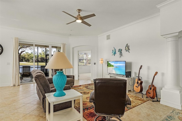 living room featuring light tile patterned floors, crown molding, decorative columns, and ceiling fan