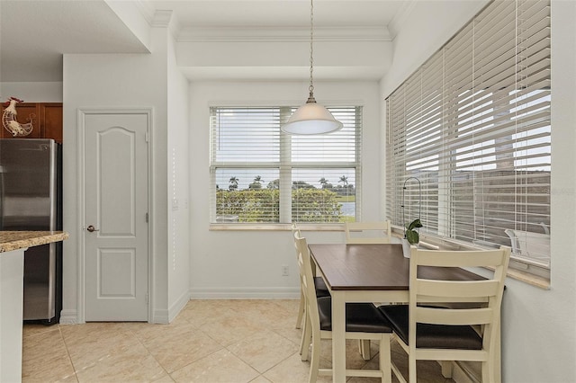 tiled dining space featuring ornamental molding