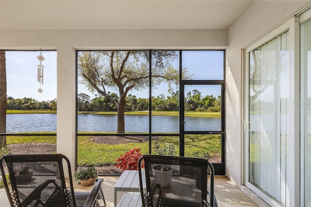 sunroom / solarium with a water view