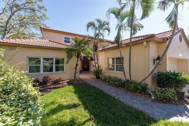 mediterranean / spanish home with a front yard