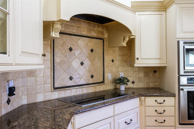 kitchen featuring backsplash, white cabinetry, and appliances with stainless steel finishes