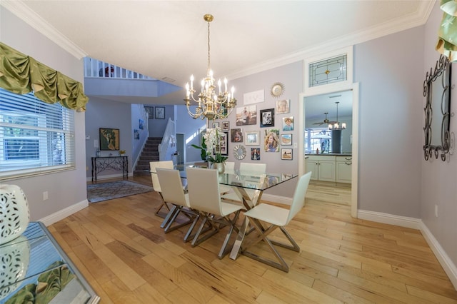 dining room with ornamental molding, an inviting chandelier, and light hardwood / wood-style floors