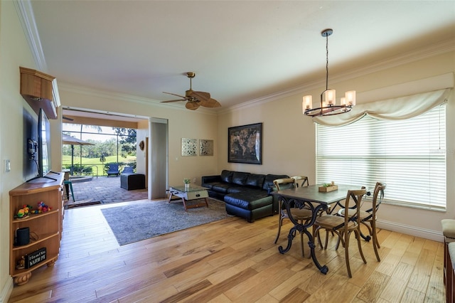 dining space featuring plenty of natural light, ornamental molding, and light wood-type flooring