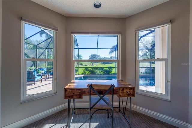 carpeted dining area featuring a textured ceiling