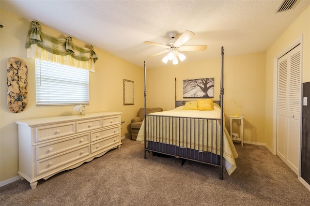 bedroom with ceiling fan, carpet, a closet, and a textured ceiling