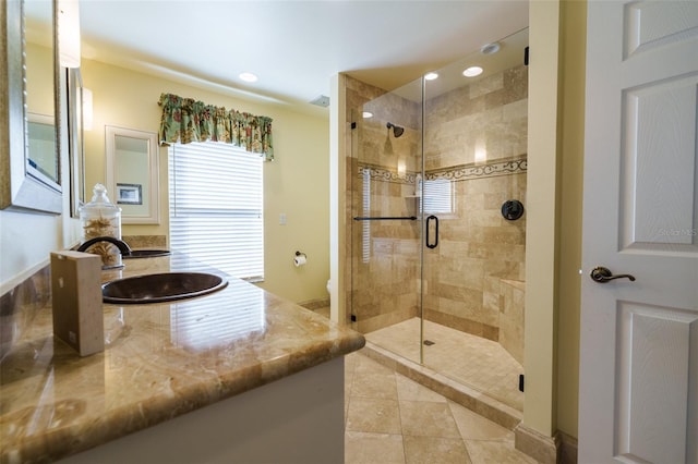 bathroom with vanity, toilet, tile patterned floors, and a shower with door