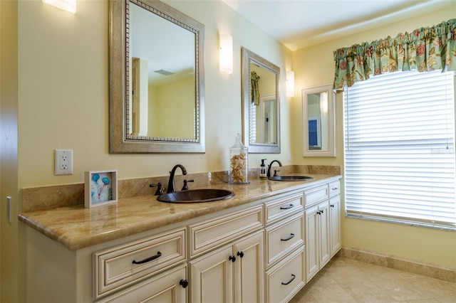 bathroom with plenty of natural light, vanity, and tile patterned flooring