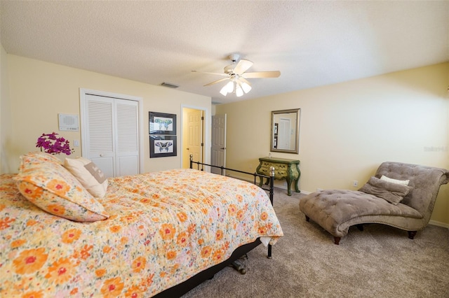 carpeted bedroom featuring a textured ceiling, a closet, and ceiling fan