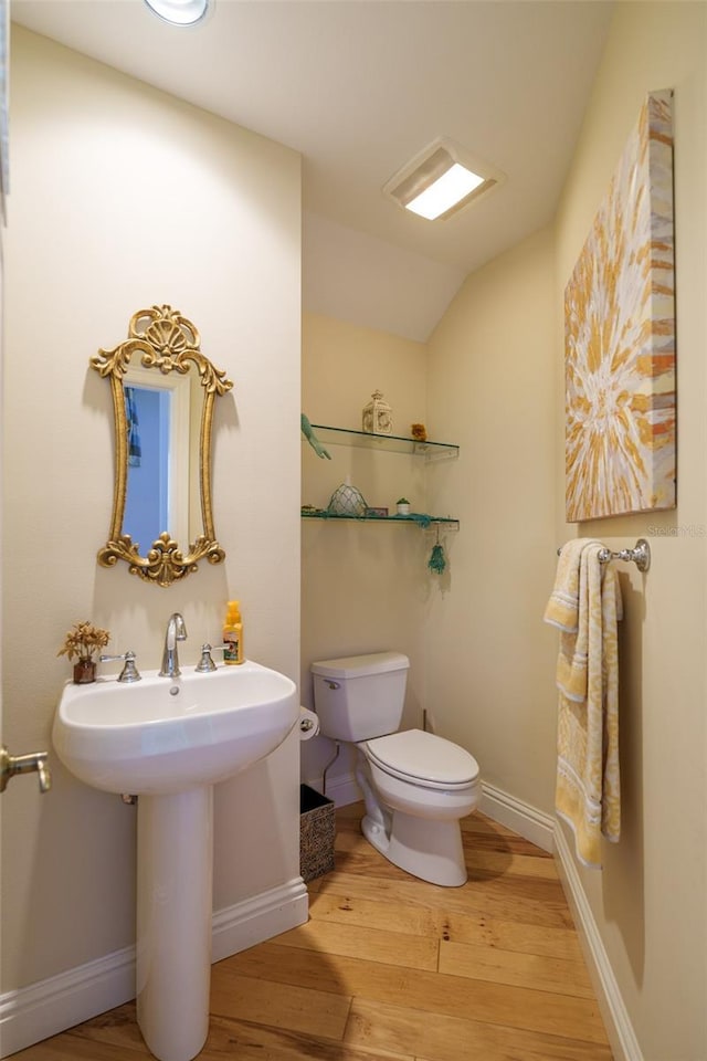 bathroom featuring hardwood / wood-style floors and toilet