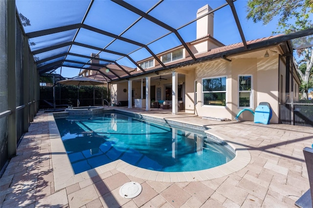 view of pool featuring an in ground hot tub, a lanai, ceiling fan, and a patio