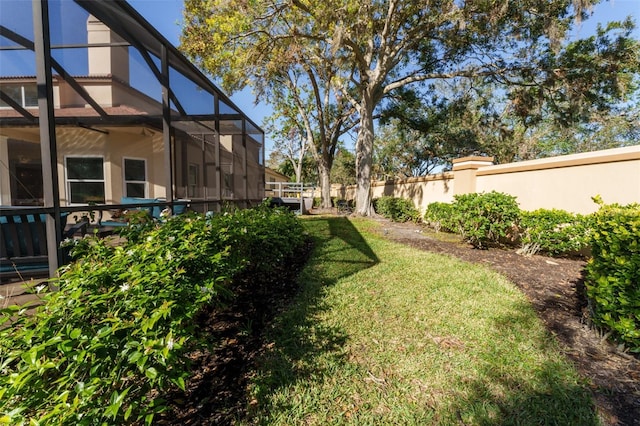 view of yard featuring glass enclosure