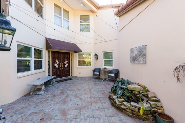 doorway to property with a patio area