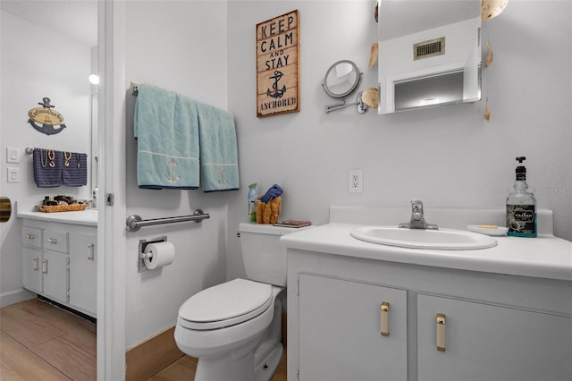 bathroom featuring toilet and vanity