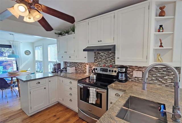 kitchen with white cabinets, stainless steel range with electric stovetop, sink, and exhaust hood