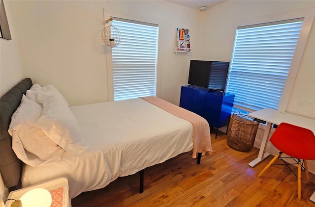 bedroom with hardwood / wood-style flooring