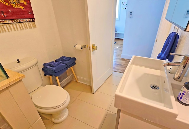 bathroom with sink, tile patterned floors, and toilet