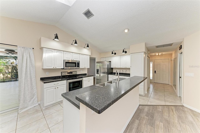 kitchen with white cabinetry, sink, a kitchen island with sink, and stainless steel appliances