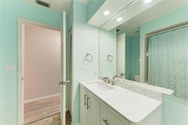 bathroom with vanity and toilet