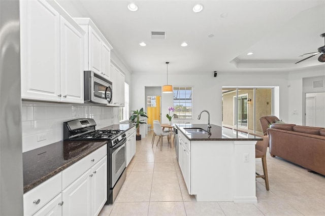 kitchen featuring white cabinetry, sink, pendant lighting, an island with sink, and stainless steel appliances
