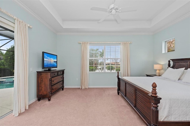 carpeted bedroom with ornamental molding, ceiling fan, and a raised ceiling