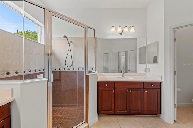 bathroom featuring vanity, an enclosed shower, and tile patterned flooring