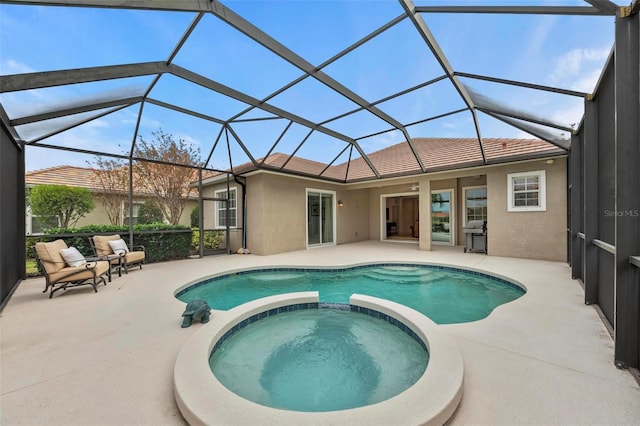 view of swimming pool with glass enclosure, an in ground hot tub, and a patio