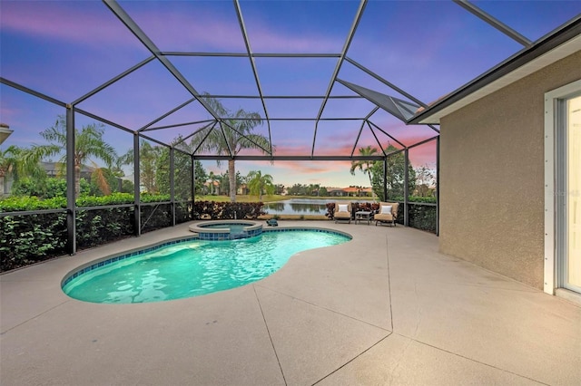 pool at dusk featuring an in ground hot tub, a lanai, a water view, and a patio