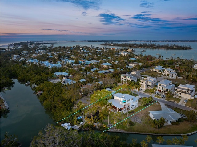 aerial view at dusk with a water view