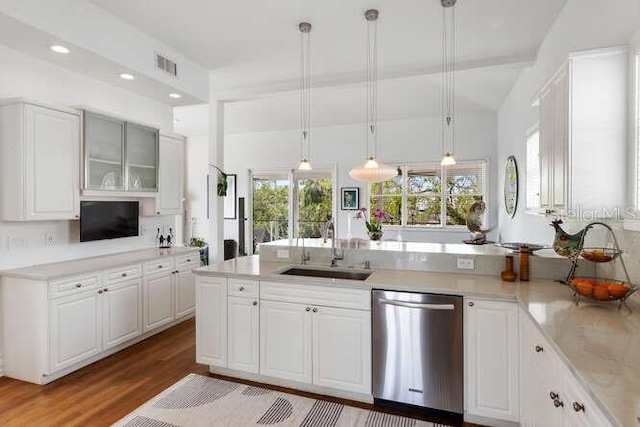 kitchen with sink, hanging light fixtures, dishwasher, hardwood / wood-style flooring, and white cabinets