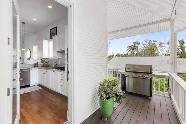 deck featuring exterior kitchen, area for grilling, and sink