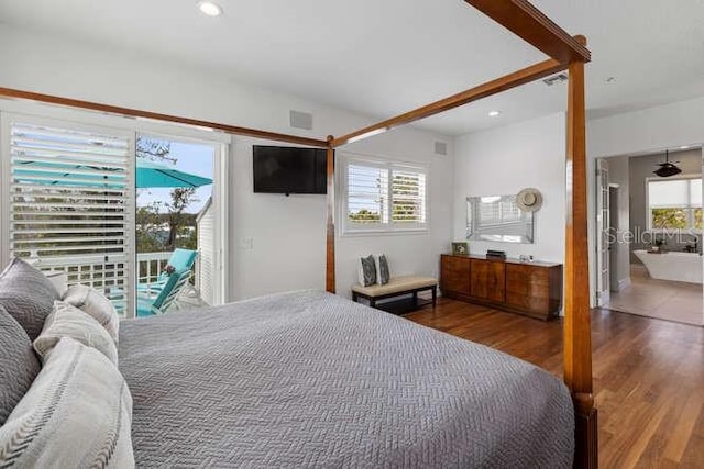 bedroom with access to exterior and hardwood / wood-style flooring