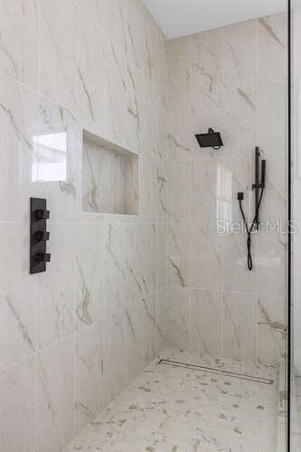 bathroom with tiled shower