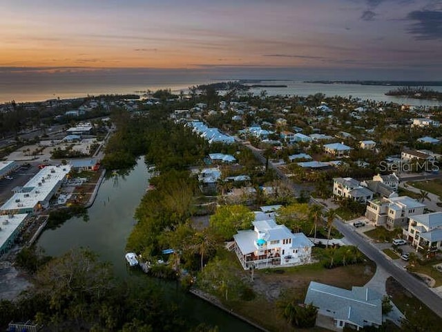 aerial view at dusk with a water view