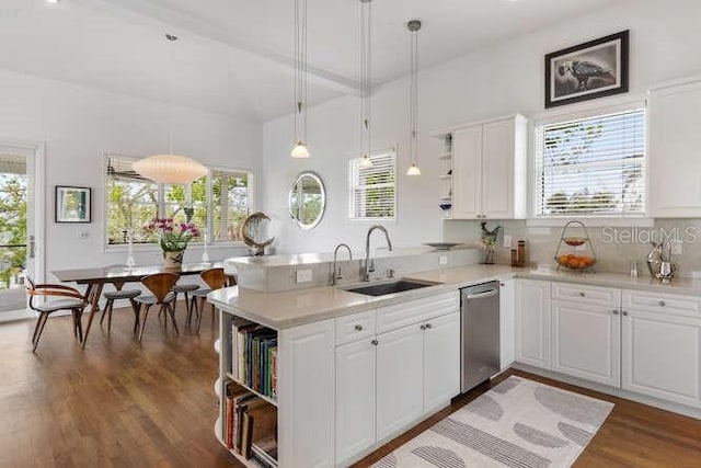 6821 Longboat Dr S, Longboat Key, FL 34228 - kitchen featuring open shelves, a sink, stainless steel dishwasher, a peninsula, and wood finished floors
