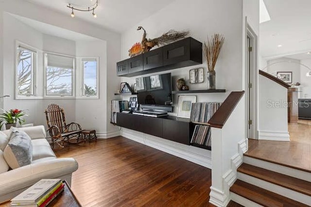 6821 Longboat Dr S, Longboat Key, FL 34228 - living area featuring dark wood-style floors, stairway, and baseboards