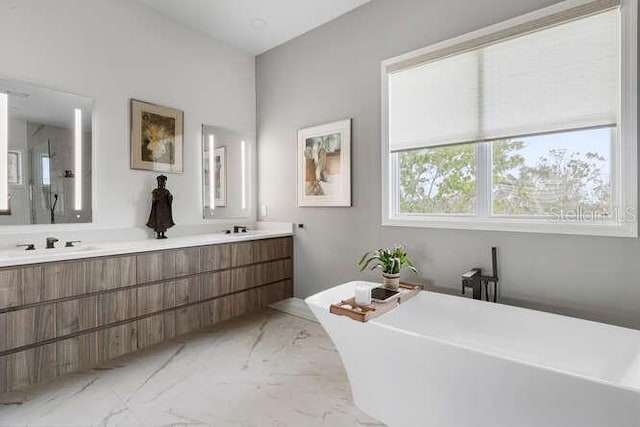 6821 Longboat Dr S, Longboat Key, FL 34228 - full bathroom with marble finish floors, double vanity, and a freestanding tub