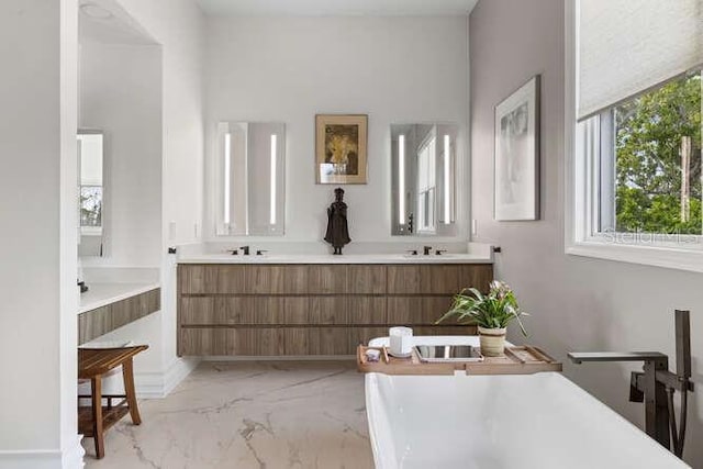 6821 Longboat Dr S, Longboat Key, FL 34228 - full bathroom with marble finish floors, a freestanding tub, and double vanity