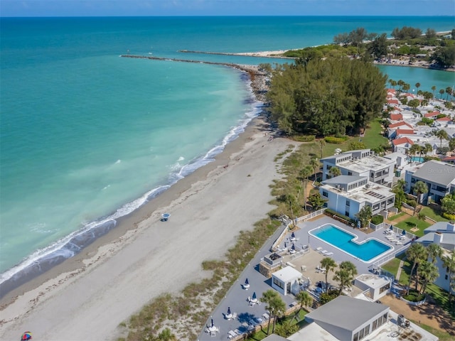 drone / aerial view with a water view and a beach view