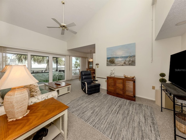 living room with ceiling fan, high vaulted ceiling, and carpet flooring