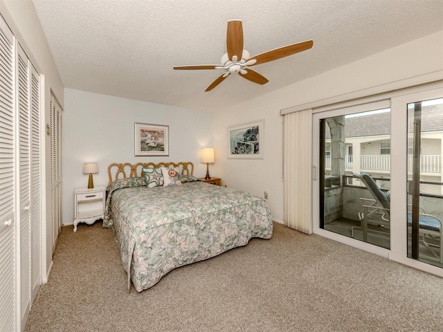 bedroom with a textured ceiling, carpet floors, a closet, access to outside, and ceiling fan