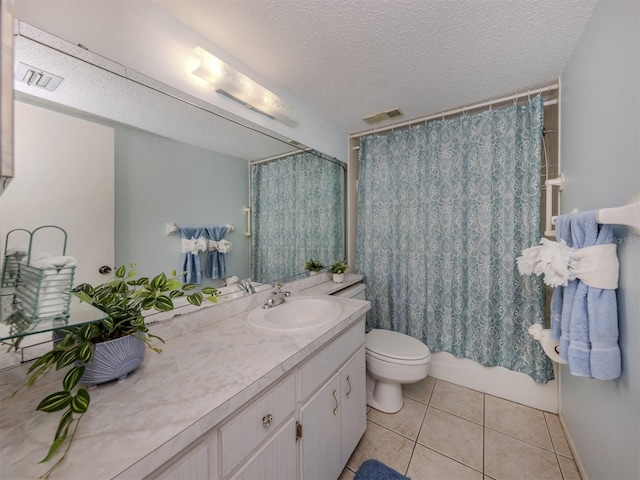 full bathroom featuring toilet, a textured ceiling, shower / tub combo with curtain, tile patterned floors, and vanity