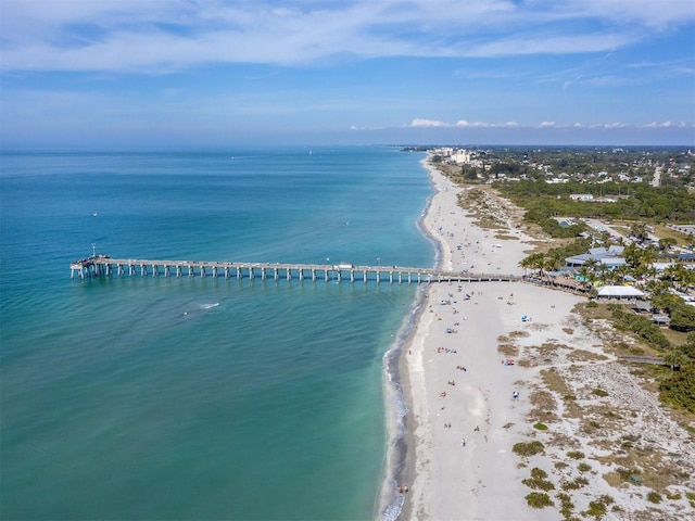 birds eye view of property featuring a beach view and a water view