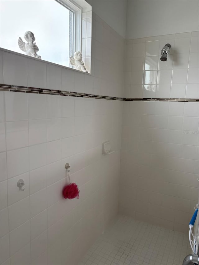 bathroom with a tile shower