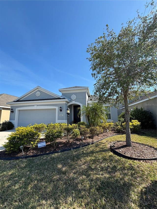 ranch-style home with a garage and a front lawn