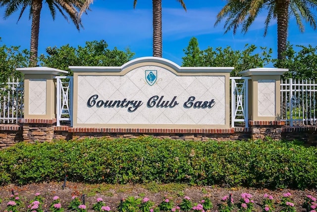 community / neighborhood sign with fence