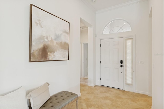 entrance foyer with baseboards and crown molding